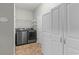 Functional laundry room with a washer, dryer, and ample storage cabinets at 2135 Starduster Ln., Little River, SC 29566