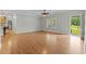 A living room featuring laminate flooring, a ceiling fan, and a back door entrance at 2135 Starduster Ln., Little River, SC 29566