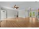 Open living room boasts hardwood floors, ceiling fans and natural light from the French doors at 2135 Starduster Ln., Little River, SC 29566