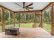 Screened-in porch featuring a fire pit and fan at 2135 Starduster Ln., Little River, SC 29566