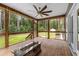 Wide angle of the screened-in porch featuring a fire pit and fan at 2135 Starduster Ln., Little River, SC 29566