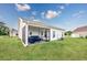 A white house with screened in porch and green lawn extending to the property line at 2143 Stonecrest Dr. Nw, Calabash, NC 28467
