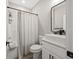 Bathroom features a single sink vanity with a large mirror and a shower-tub combo at 2143 Stonecrest Dr. Nw, Calabash, NC 28467