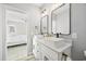 Bathroom featuring double sink vanity, white cabinets, quartz countertop, and modern black fixtures at 2143 Stonecrest Dr. Nw, Calabash, NC 28467