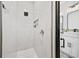 Bright bathroom boasts a spacious shower with white marble-look tile and black fixtures at 2143 Stonecrest Dr. Nw, Calabash, NC 28467