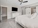 Bright bedroom with a large bed, sliding barn door, and grey wood-look flooring at 2143 Stonecrest Dr. Nw, Calabash, NC 28467