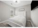 Well-lit bedroom features a plush queen bed and a large window at 2143 Stonecrest Dr. Nw, Calabash, NC 28467