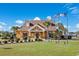Exterior of community clubhouse with well-manicured lawn, mature trees, and flagpoles at 2143 Stonecrest Dr. Nw, Calabash, NC 28467