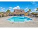 Community pool with tables, lounge chairs, palm trees, and clubhouse at 2143 Stonecrest Dr. Nw, Calabash, NC 28467