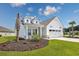 Charming white home with a well-manicured lawn, inviting curb appeal, and an attached two-car garage at 2143 Stonecrest Dr. Nw, Calabash, NC 28467