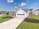 Exterior view of a two story house with a two car garage and a well manicured lawn at 2143 Stonecrest Dr. Nw, Calabash, NC 28467