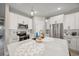 Modern kitchen with white cabinets, quartz countertops, stainless steel appliances, and a large center island at 2143 Stonecrest Dr. Nw, Calabash, NC 28467