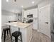 Bright kitchen features white cabinets, quartz countertops, pendant lighting, and stainless steel appliances at 2143 Stonecrest Dr. Nw, Calabash, NC 28467