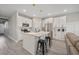 Modern kitchen with white cabinets, an island with seating, stainless steel appliances, and stylish pendant lights at 2143 Stonecrest Dr. Nw, Calabash, NC 28467