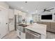 Gourmet kitchen showcasing stainless steel appliances, quartz countertops, island sink, and open layout to living area at 2143 Stonecrest Dr. Nw, Calabash, NC 28467