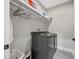 Functional laundry room equipped with modern appliances and ample shelving for storage at 2143 Stonecrest Dr. Nw, Calabash, NC 28467