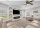 Comfortable living room boasts a modern entertainment center, fireplace, and abundant natural light at 2143 Stonecrest Dr. Nw, Calabash, NC 28467