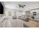 Cozy living room open to the kitchen featuring a ceiling fan and plenty of natural light at 2143 Stonecrest Dr. Nw, Calabash, NC 28467