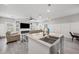 Open-concept living room with white trim, large island with stainless steel sink, and neutral colored sectional sofa at 2143 Stonecrest Dr. Nw, Calabash, NC 28467