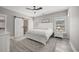 Serene main bedroom features neutral tones, wood-look floors, a barn door to the ensuite, and plenty of natural light at 2143 Stonecrest Dr. Nw, Calabash, NC 28467