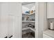 Walk-in pantry with white shelving and plenty of storage space for food and kitchen essentials at 2143 Stonecrest Dr. Nw, Calabash, NC 28467