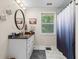 Bathroom with marble floors, modern vanity, decorative mirror, and walk-in shower at 241 Fannie B Rd., Conway, SC 29526