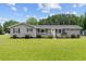 Charming one-story home featuring gray siding, black shutters, and a well-manicured front yard at 241 Fannie B Rd., Conway, SC 29526