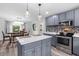 Charming kitchen with island, gray cabinets, stainless appliances, and view to dining area at 241 Fannie B Rd., Conway, SC 29526