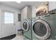 Convenient laundry room with modern washer and dryer, storage cabinets, and back door access at 241 Fannie B Rd., Conway, SC 29526