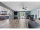 Bright living room with modern ceiling fan, wood floors, and view to kitchen at 241 Fannie B Rd., Conway, SC 29526