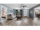Spacious living room with a gray couch, modern ceiling fan, and entrance to dining room at 241 Fannie B Rd., Conway, SC 29526