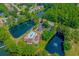 Beautiful aerial view of a community with a pool, lakes, and lush green spaces, offering resort-style living at 2454 Glen Dr., Little River, SC 29566