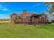 The expansive backyard features a well-maintained lawn and a cozy, covered patio perfect for outdoor gatherings and relaxation at 2454 Glen Dr., Little River, SC 29566