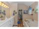 Bright bathroom boasts a double sink vanity, bathtub, shower, and walk-in closet at 2454 Glen Dr., Little River, SC 29566