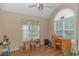 A naturally lit bedroom with a desk, neutral walls, and a ceiling fan at 2454 Glen Dr., Little River, SC 29566