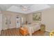 Bedroom with tray ceiling, hardwood floors, decorative curtains, and painting at 2454 Glen Dr., Little River, SC 29566