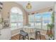 Sunny dining nook with large windows, stylish lighting, and a cozy table setting at 2454 Glen Dr., Little River, SC 29566