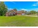 Brick home with a manicured lawn, two-car garage, and mature trees at 2454 Glen Dr., Little River, SC 29566