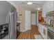 Bright kitchen area showcasing stainless steel appliances, granite countertops, and wood flooring at 2454 Glen Dr., Little River, SC 29566