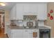 Kitchen featuring granite countertops, white subway tile backsplash, and stainless steel dishwasher at 2454 Glen Dr., Little River, SC 29566