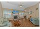 Comfortable living room with a fireplace, ceiling fan, and hardwood floors at 2454 Glen Dr., Little River, SC 29566