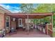 Inviting covered patio features an outdoor kitchen, seating, and a warm, rustic ambiance for relaxing and entertaining at 2454 Glen Dr., Little River, SC 29566