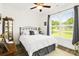 Bright bedroom with large window, ceiling fan, wood floors, neutral color scheme and classic furniture at 2588 Long Avenue Ext., Conway, SC 29526
