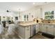 Open-concept kitchen with stainless steel appliances, granite countertops and an eat-in bar connecting the living area at 2588 Long Avenue Ext., Conway, SC 29526