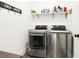This clean laundry room is equipped with side-by-side washer and dryer units with a convenient shelf for supplies at 2588 Long Avenue Ext., Conway, SC 29526