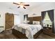 Comfortable main bedroom with a large bed, wooden accents, a sliding barn door and abundant natural light at 2588 Long Avenue Ext., Conway, SC 29526