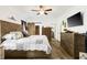 Cozy main bedroom featuring wood floors, accent furniture, a sliding barn door, and a ceiling fan at 2588 Long Avenue Ext., Conway, SC 29526