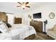 Bright main bedroom with wood floors, a sliding barn door, accent furniture, and a ceiling fan at 2588 Long Avenue Ext., Conway, SC 29526