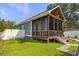Charming screened porch with outdoor seating and steps leading to the backyard at 2588 Long Avenue Ext., Conway, SC 29526