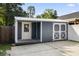 Exterior view of the backyard storage shed with double doors and a covered porch at 2588 Long Avenue Ext., Conway, SC 29526